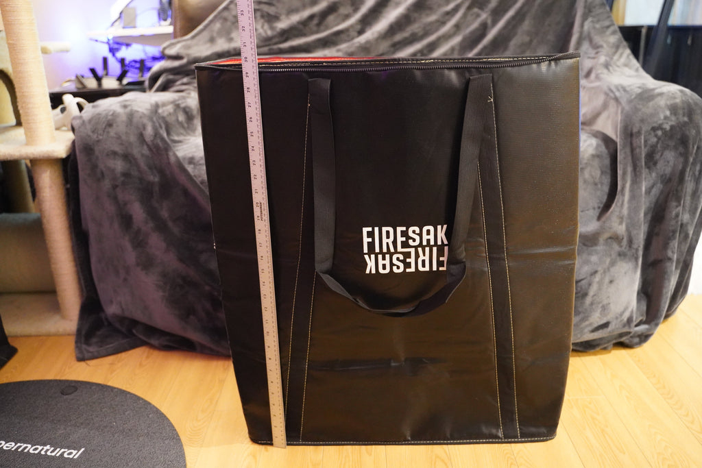 Black bag with 'FIRESAK' branding on a wooden surface