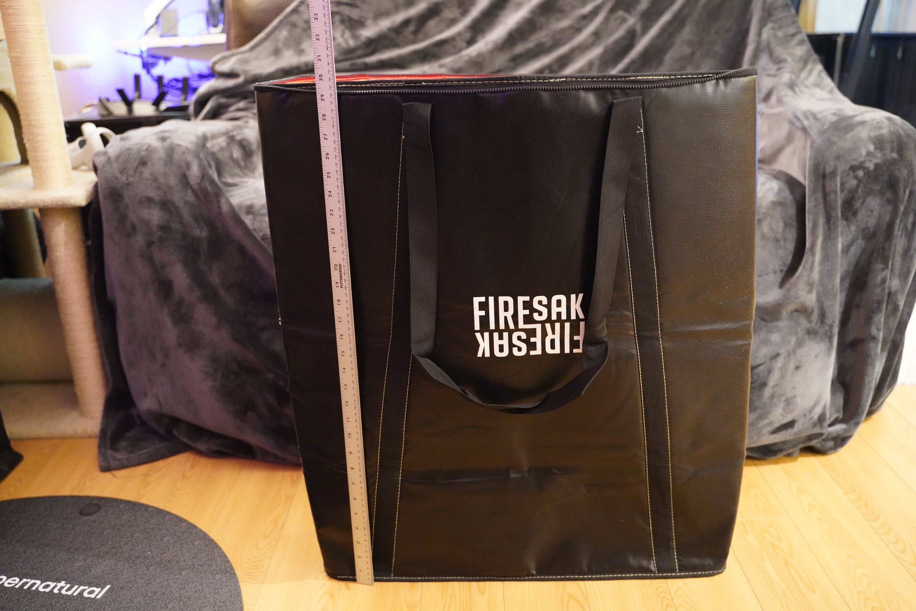 Black bag with 'FIRESAK' branding on a wooden surface